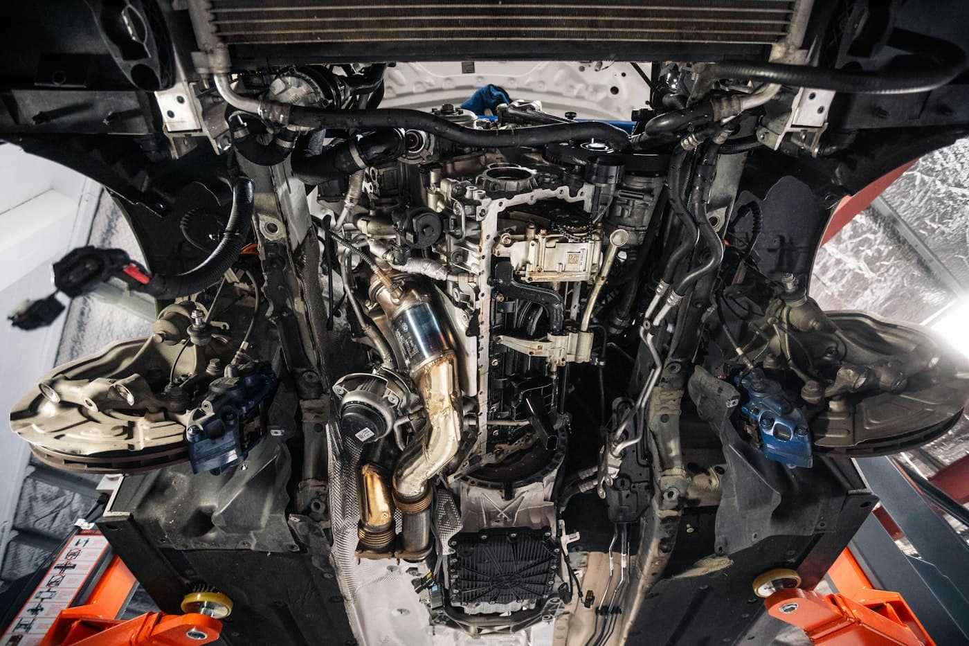 An engine bay viewed from above during a mechanical inspection